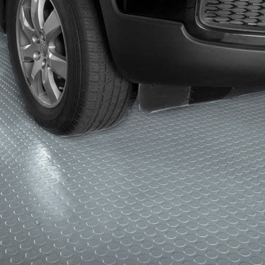 Car tyre on grey hex-patterned interlocking PVC garage floor tiles