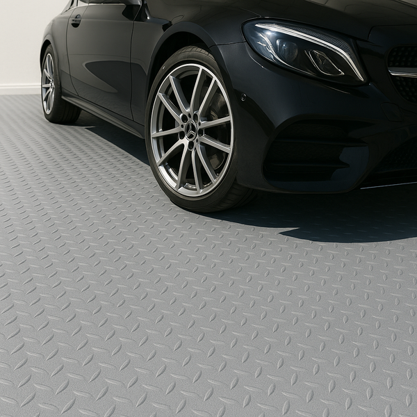 Grey diamond tread rubber flooring with car parked on top, heavy-duty non-slip mat ideal for workshops, garages & commercial spaces; sold in 5m & 10m rolls