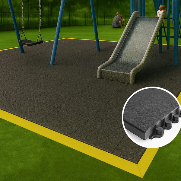 Playground area with non-slip rubber mat tiles featuring a slide and swing set on green grass for safe play