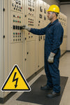Worker standing on low-voltage electrical insulation mat (Class 0) in switchgear room with yellow high-voltage hazard sign; IEC 61111 Class 0 ribbed rubber safety mat 1 m wide and 3 mm thick, rated to 1 kV for electrical insulation and slip resistance.