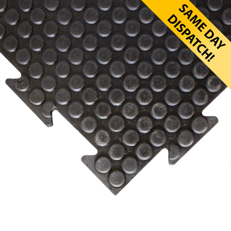 Close-up of interlocking studded walkway mat tile with puzzle edge; heavy-duty natural rubber/SBR tile with raised coin studs and yellow 'SAME DAY DISPATCH!' banner, providing non-slip traction and easy interlocking installation for walkways, kennels and stables. Measures 1 m × 1 m and 17 mm thick.