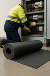 High voltage electrical insulation mat roll being installed in front of electrical switchgear; IEC 61111 Class 2 safety mat, 17 kV rated, 4 mm thick, 1 m wide EPDM rubber with fine-ribbed slip-resistant surface for industrial electrical insulation