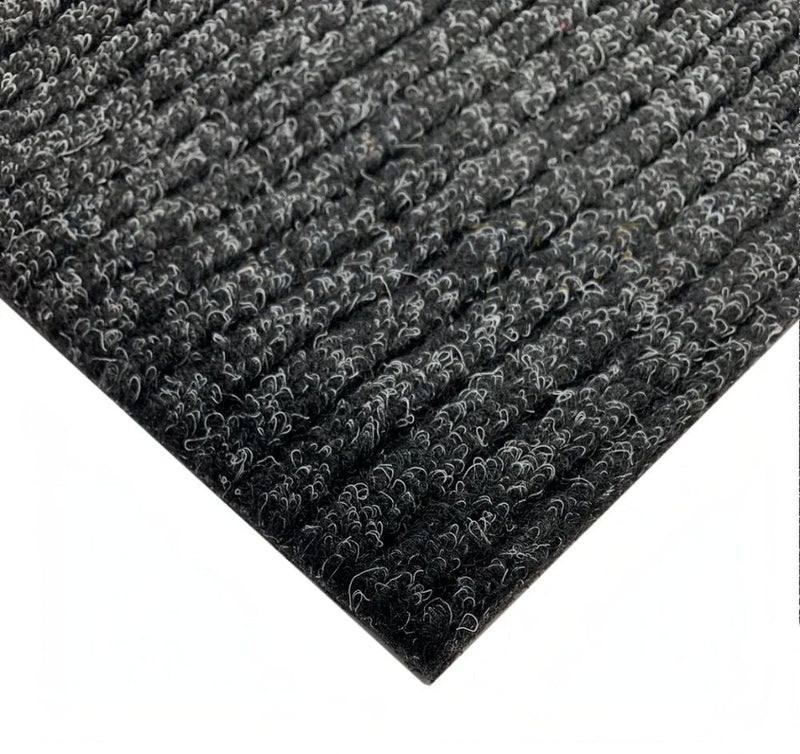 Corner detail of anthracite barrier entrance matting showing ribbed texture and latex duo backing