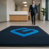 ChromaStep custom logo mat — full-colour printed entrance mat in corporate office reception, mat in sharp foreground