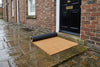 Natural coir door mat outside traditional British house front door — cut to size coir entrance matting