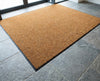 Natural coir matting installed flush in matwell — recessed into commercial building entrance floor, perfectly level with surrounding tiles
