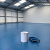 Light blue floor paint on an industrial unit floor, 20 litre tin and roller tray in the foreground