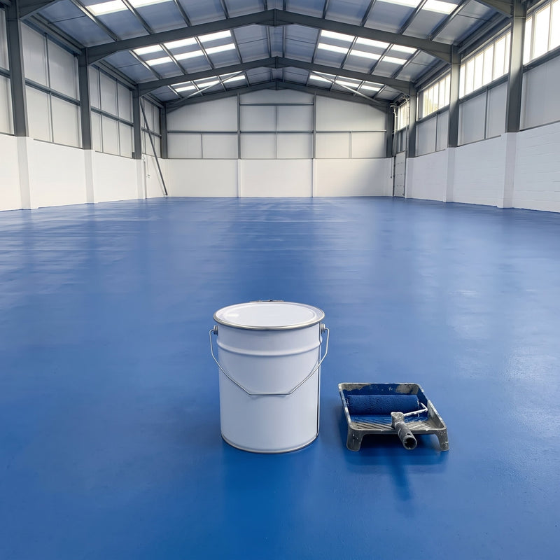 Mid blue floor paint across a large empty factory floor, 20 litre tin and roller tray