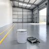 Mid grey heavy duty floor paint on a warehouse floor with yellow walkway lines, 20 litre tin and roller in front
