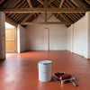 Tile red oxide floor paint in a brick workshop with timber roof trusses, 20 litre tin and roller