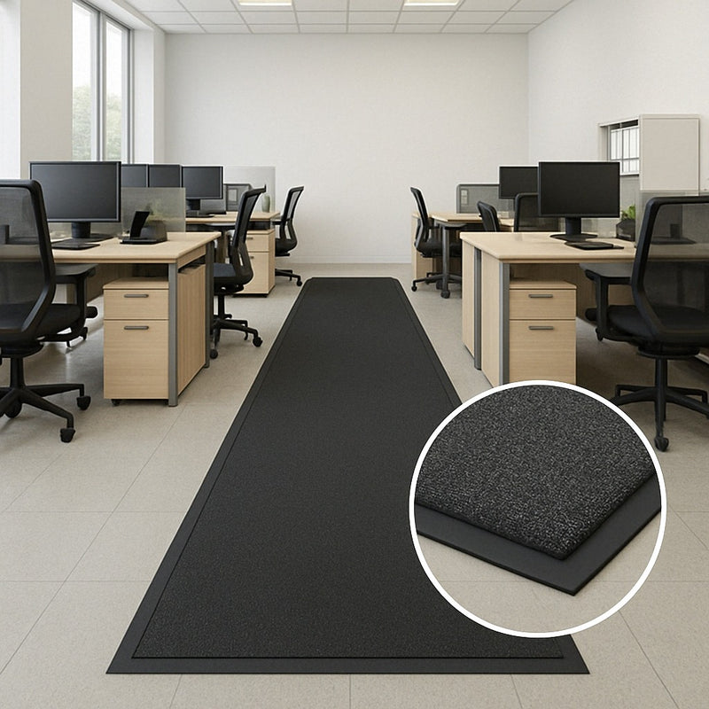 Long heavy-duty non-slip rubber runner in an office workspace with desks and chairs; ribbed texture channels water and dirt; inset shows close-up capturing moisture and improving traction; protects floors and reduces slips in busy workplace.