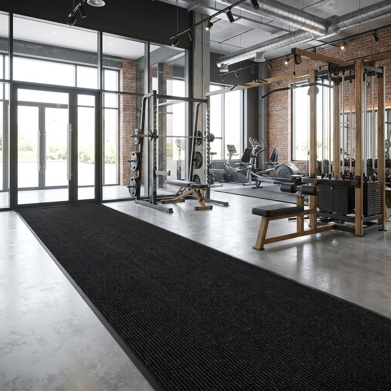 Jet black patterned polypropylene entrance matting at UK gym entrance — heavy contract Class 32, spike resistant, 10mm thick