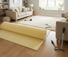 Recycled PU foam carpet underlay being laid in UK living room — 11mm thick foam roll, 3.1 TOG thermal insulation, professional installation