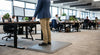 Grey anti-fatigue mat at office standing desk — 9mm PVC foam, diamond texture, pebble surface for prolonged standing comfort