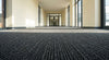 Dark anthracite fibre bonded entrance matting in UK school corridor — heavy duty, 2m and 4m wide, cut to length from 0.5m to 10m
