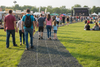 People walking on grass protection mat at event
