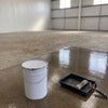 Pre Seal primer rolled onto bare warehouse concrete before painting, 20 litre tin and roller tray