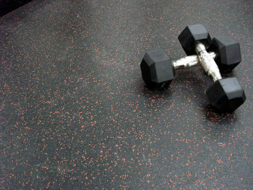 black rubber gym flooring showing white EPDM fleck pattern