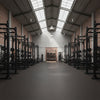 Rubber gym matting covering warehouse gym floor with squat racks — Slip-Not commercial grade flooring