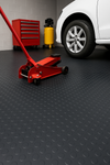 Heavy-duty non-slip rubber flooring roll with studded dot pattern in a garage and workshop; 2m wide roll protects floors and adds grip.