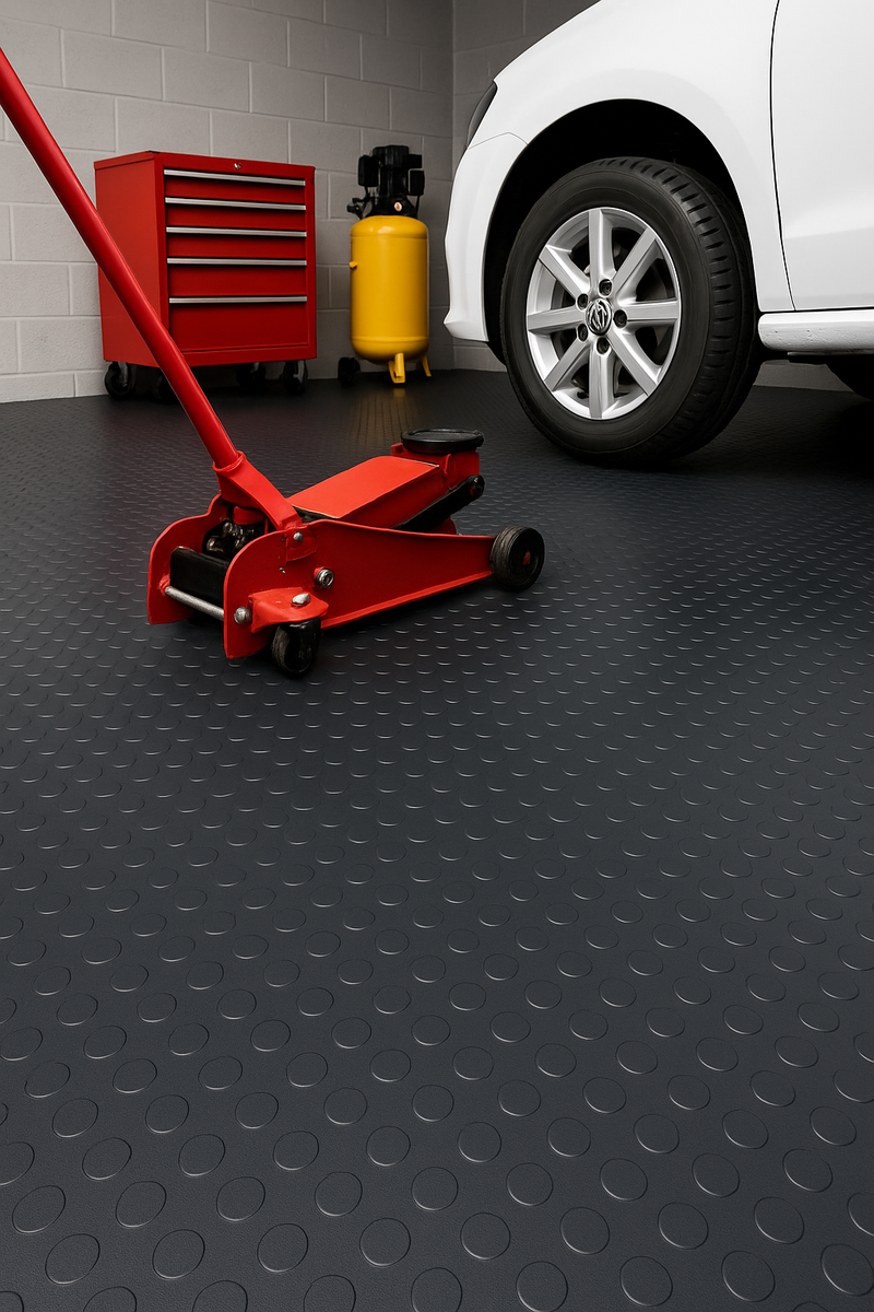 Heavy-duty non-slip rubber flooring roll with studded dot pattern in a garage and workshop; 2m wide roll protects floors and adds grip.