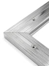 Close-up of silver chrome matwell frame mitred corner — precision engineering, pre-drilled fixing holes, polished chrome finish