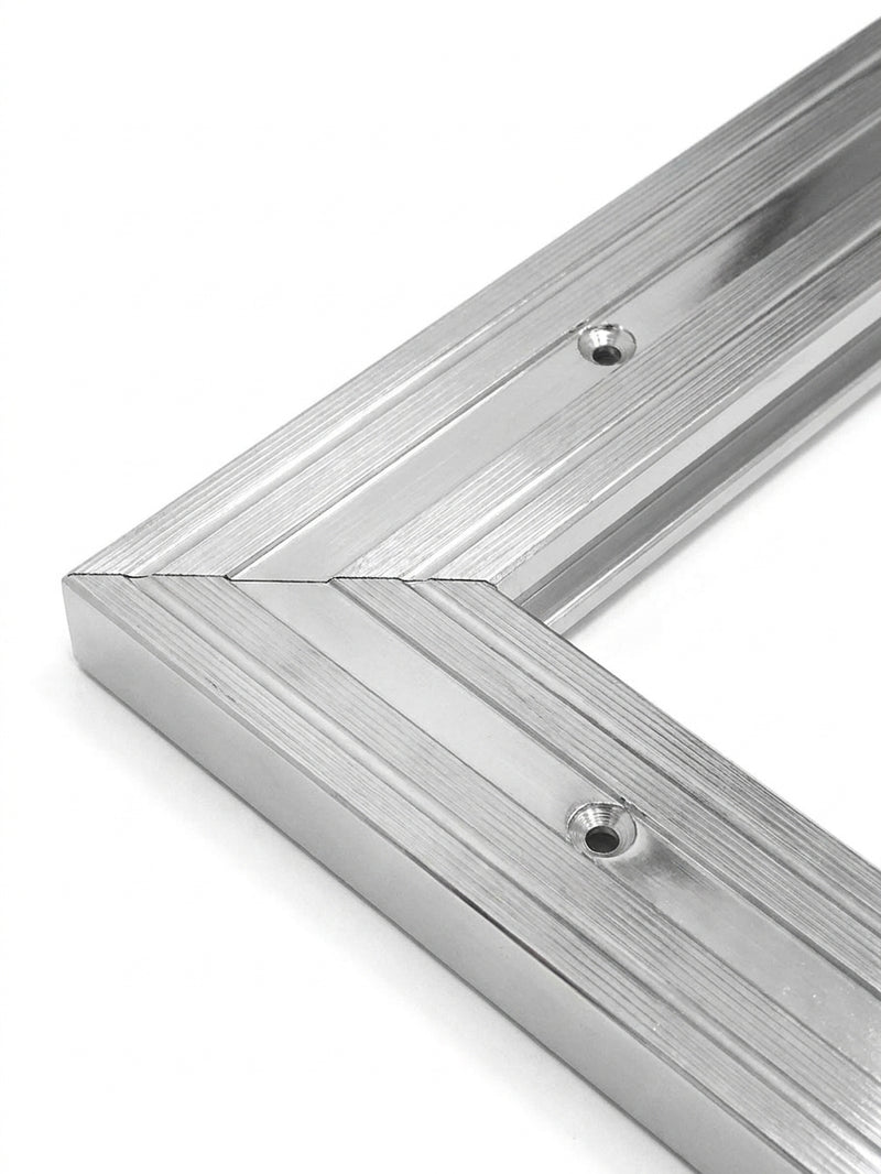 Close-up of silver chrome matwell frame mitred corner — precision engineering, pre-drilled fixing holes, polished chrome finish