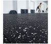White fleck rubber gym matting roll in UK gym studio — black rubber base with white EPDM flecks, seamless roll floor